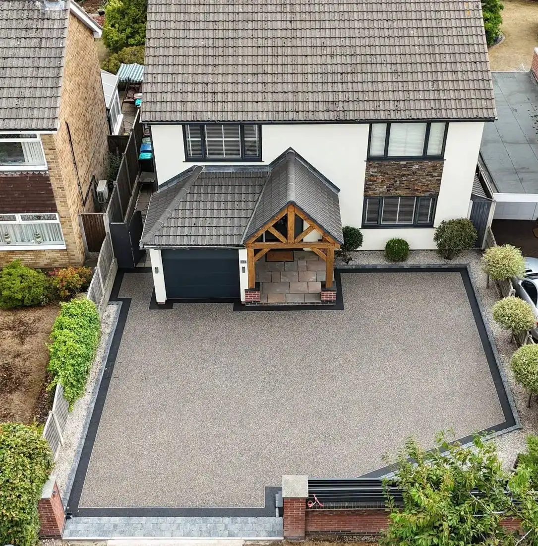 Grey resin bound driveway with an oak porch